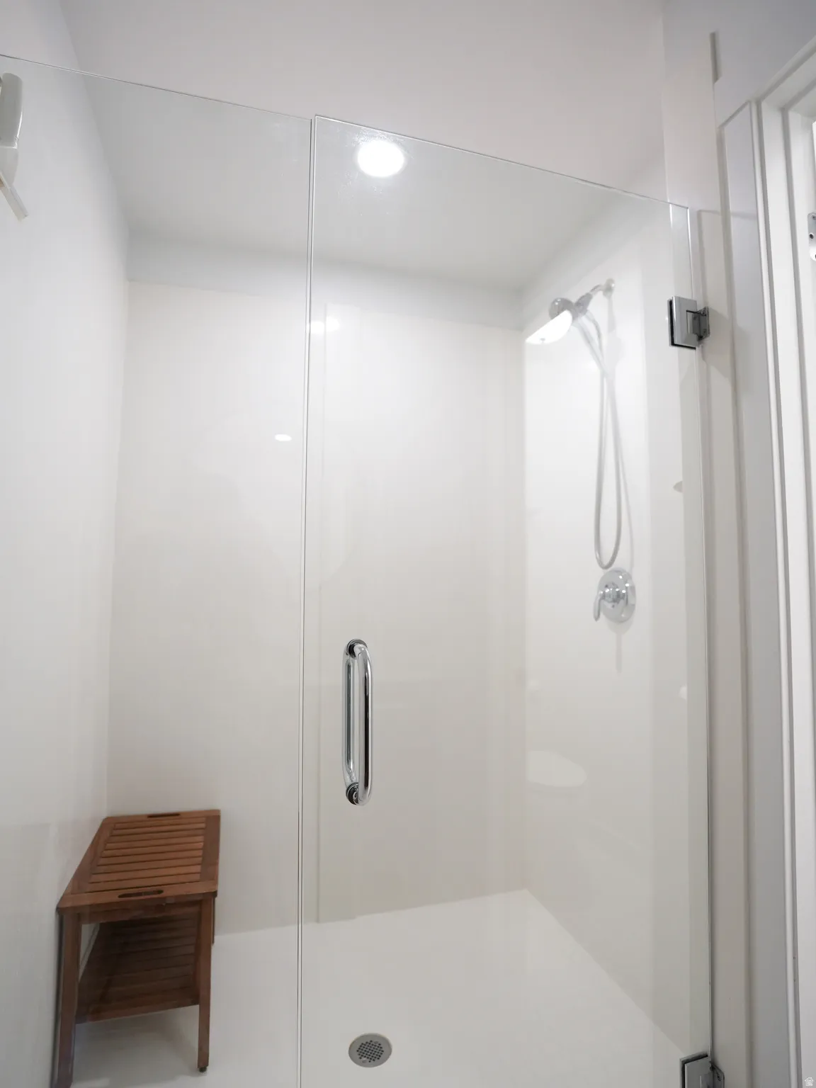 Bathroom featuring a shower stall and recessed lighting