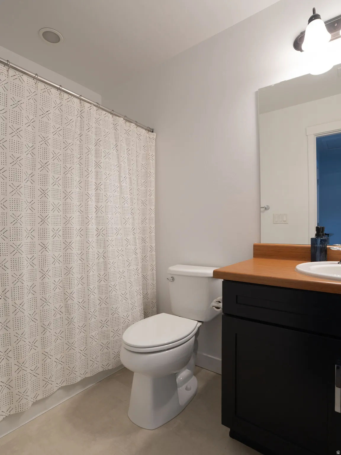 Bathroom featuring vanity and a shower with curtain