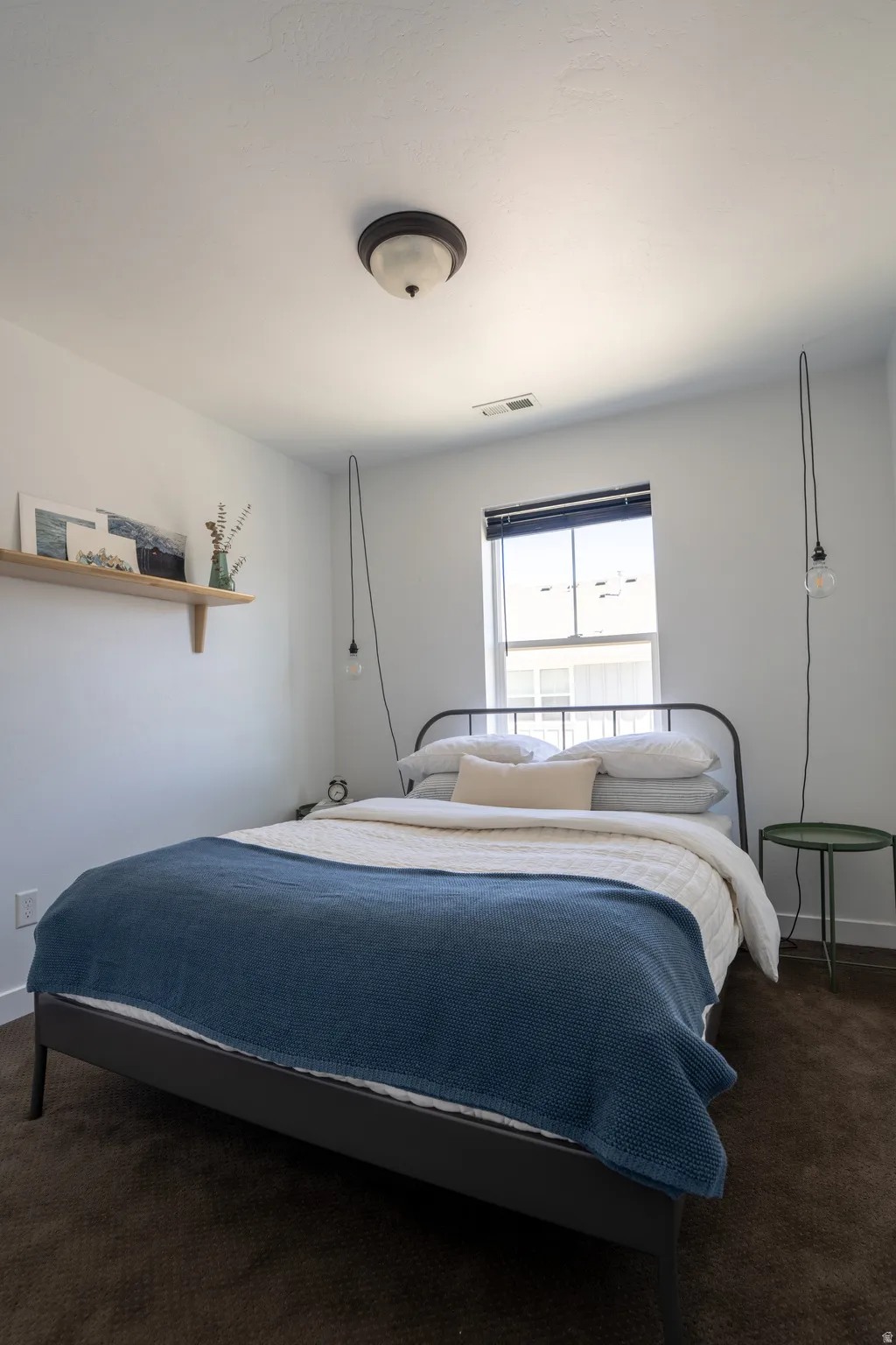 Bedroom with dark carpet and baseboards