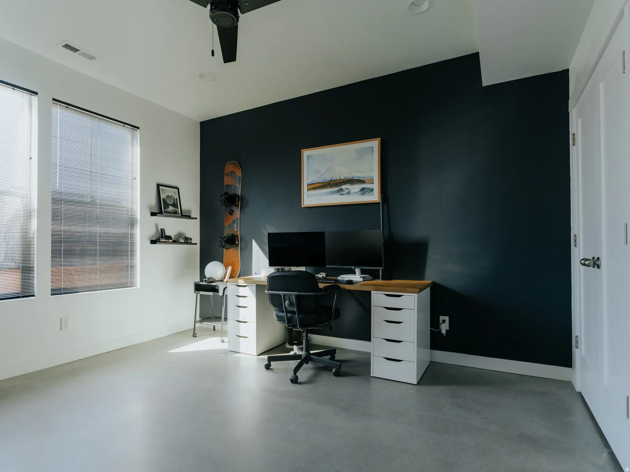 Office featuring concrete floors and a ceiling fan