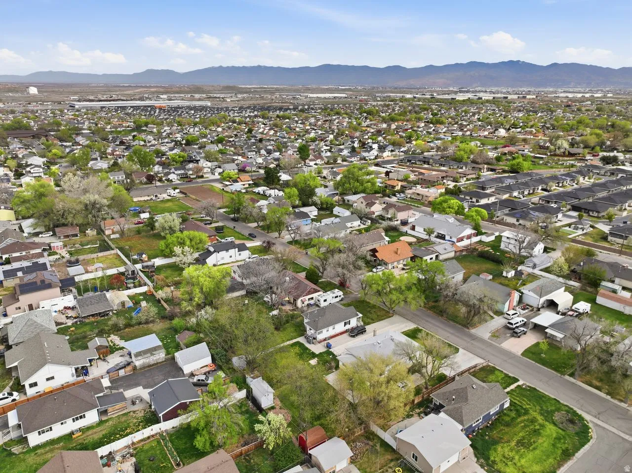 Aerial view of property's location featuring nearby suburban area and a mountain backdrop