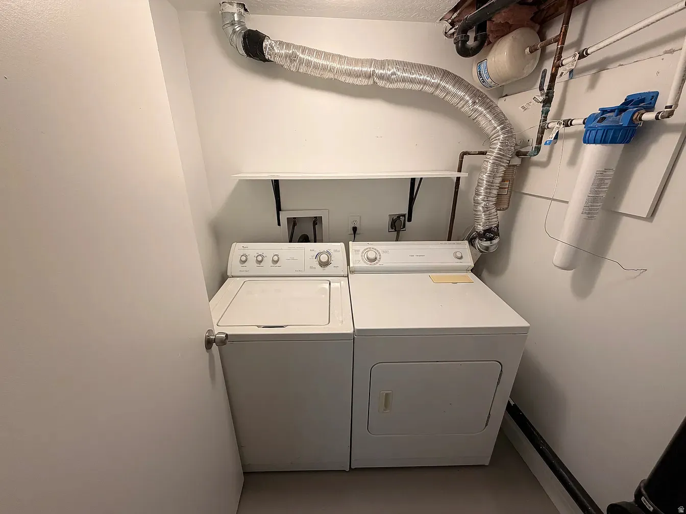 Laundry area with washing machine and clothes dryer