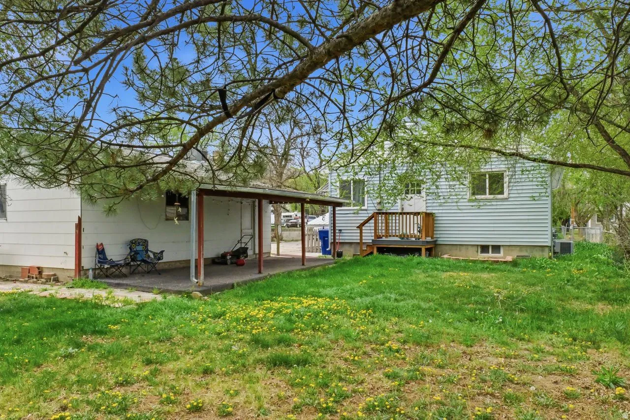 Back of property with a yard and a patio area