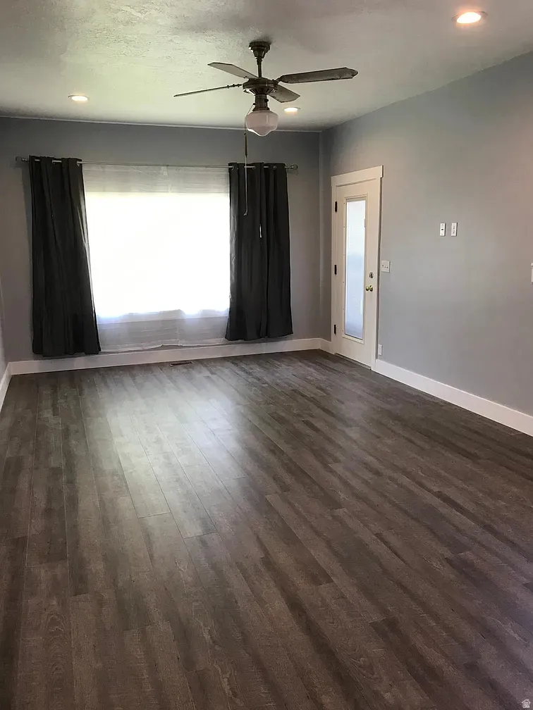 Unfurnished room featuring recessed lighting, a ceiling fan, and dark wood-type flooring