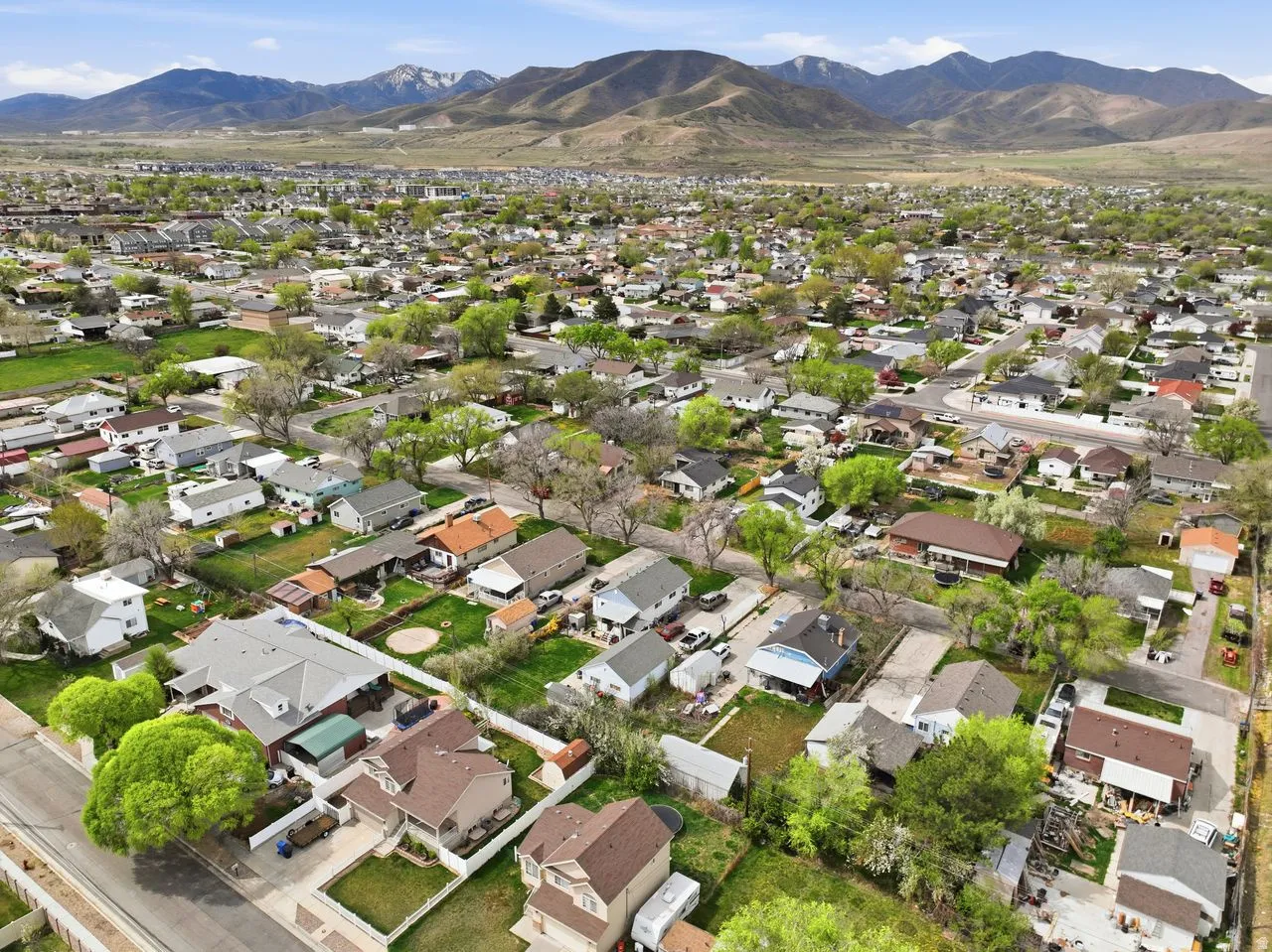 Aerial perspective of suburban area featuring a mountain backdrop