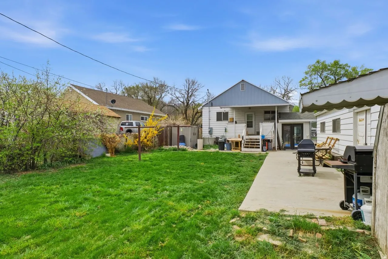 Rear view of house featuring a patio and board and batten siding