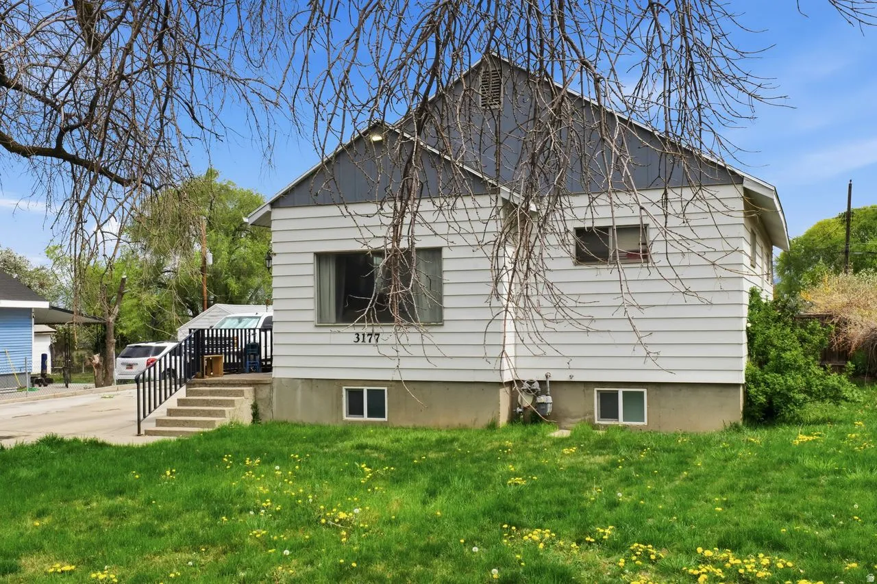 Back of property with a lawn