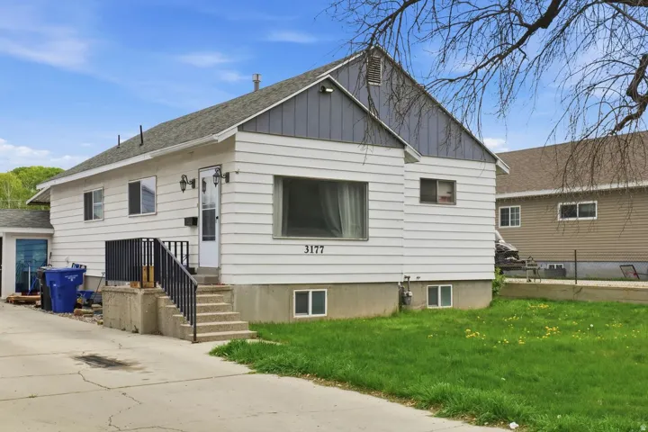 View of front of house featuring a front lawn and board and batten siding