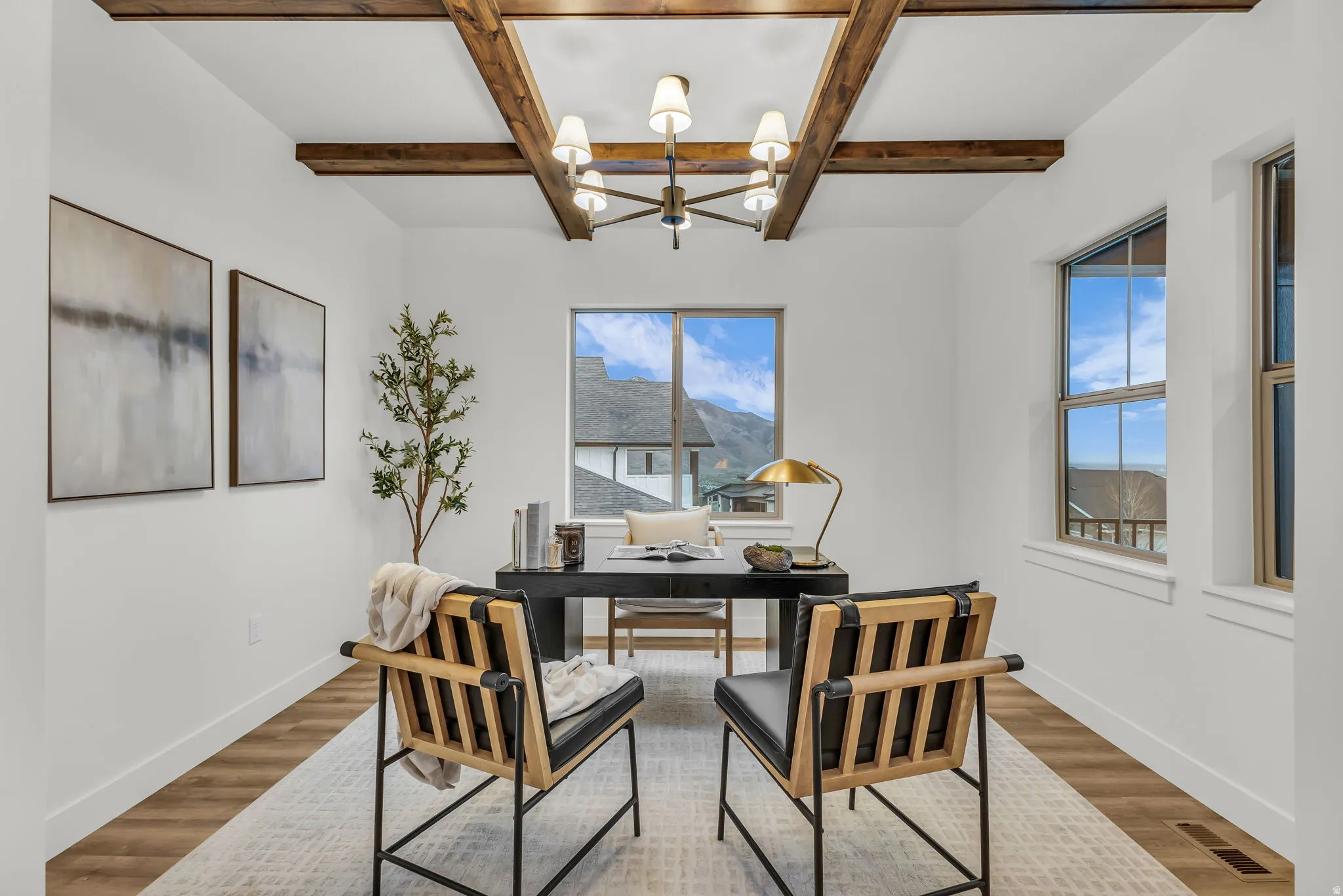 Home office featuring coffered ceiling, a chandelier, and wood finished floors