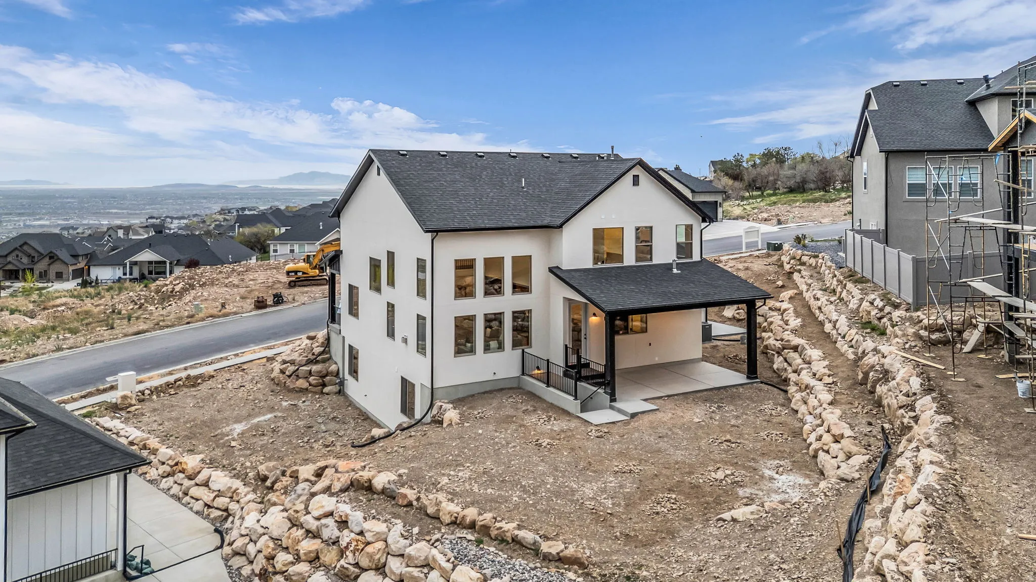 Rear view of house with a patio area, a residential view, a shingled roof, and stucco siding