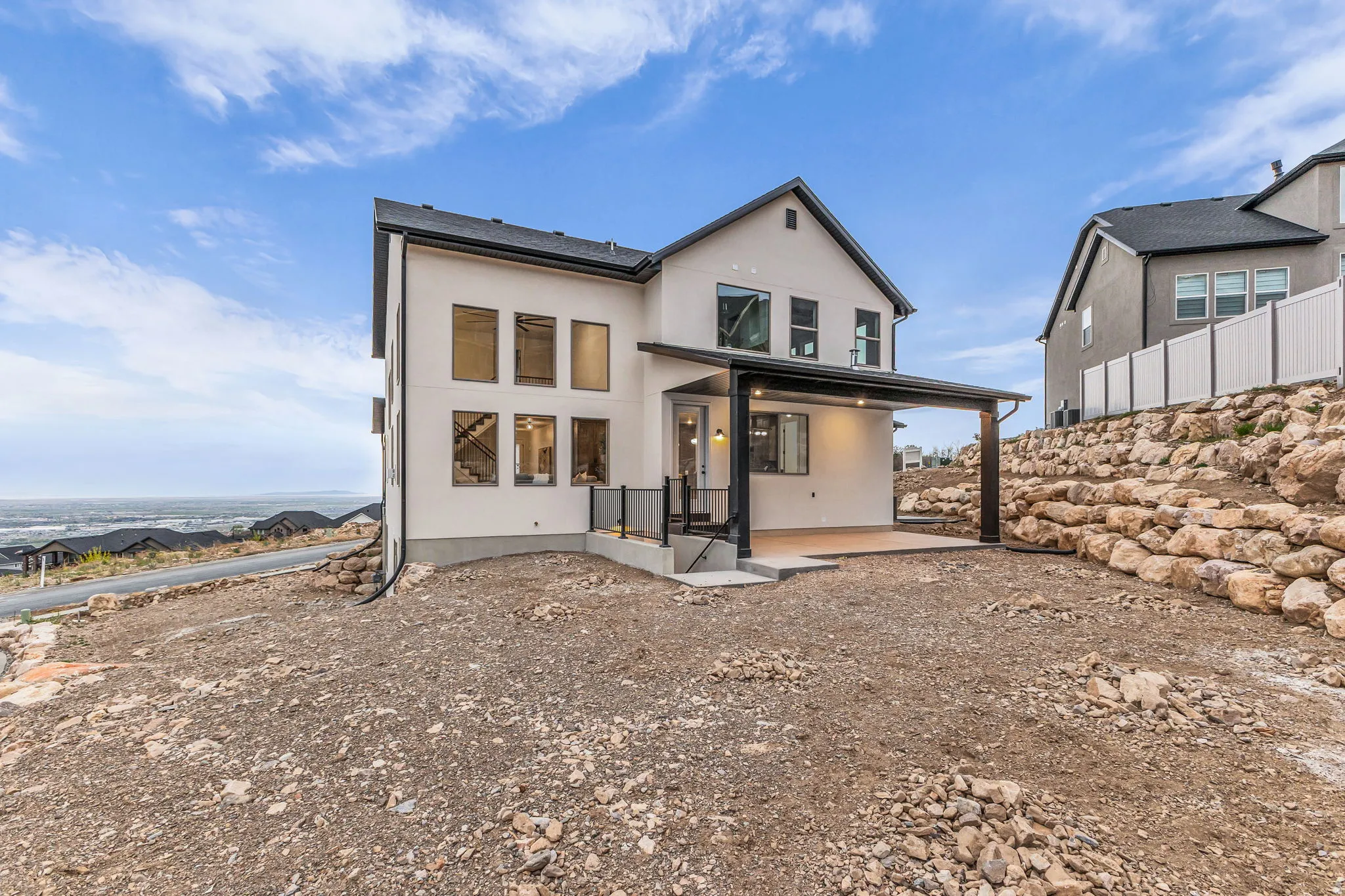 Rear view of house with a patio area and stucco siding