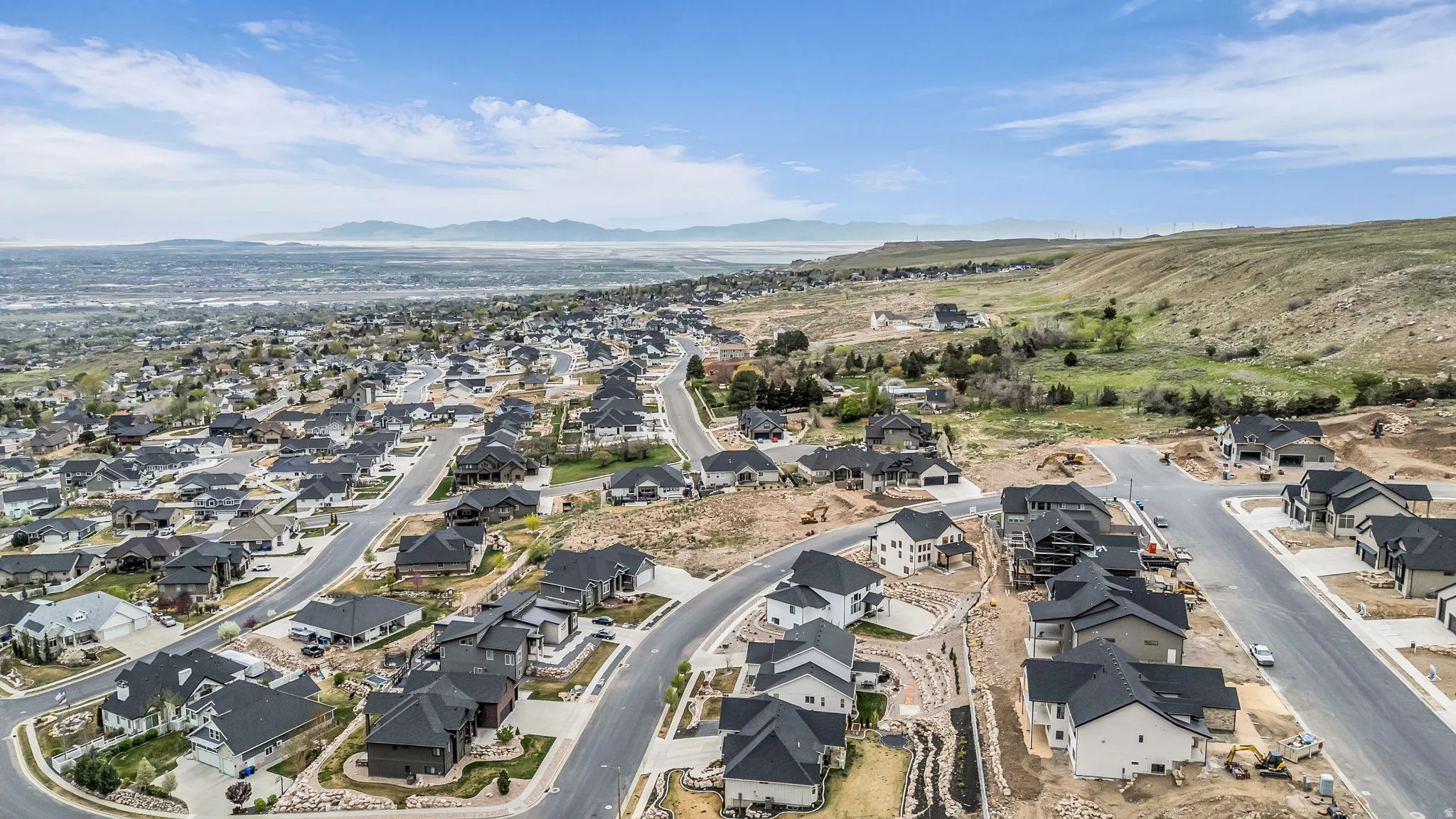Aerial perspective of suburban area featuring a mountainous background