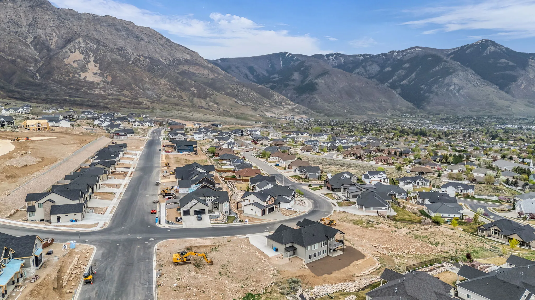 Aerial view of property's location featuring nearby suburban area and a mountain backdrop