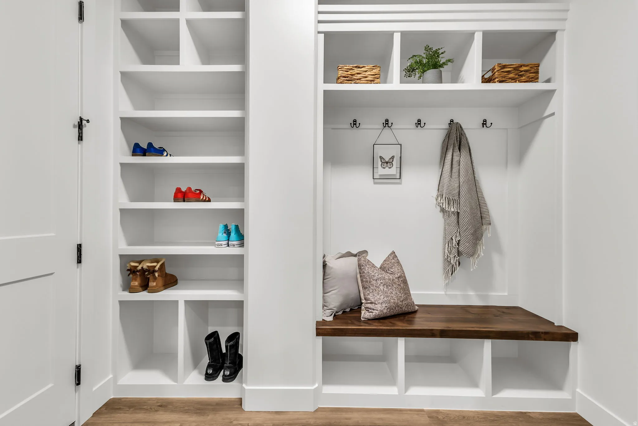 Mudroom with light wood finished floors and built in features