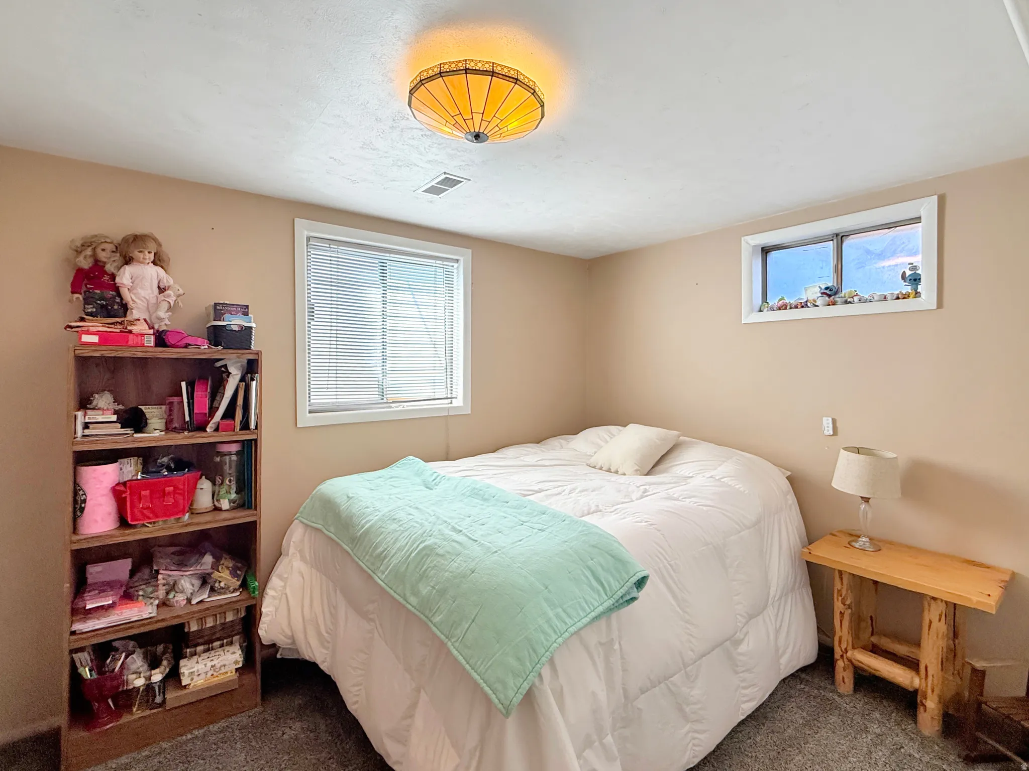 Bedroom featuring dark colored carpet