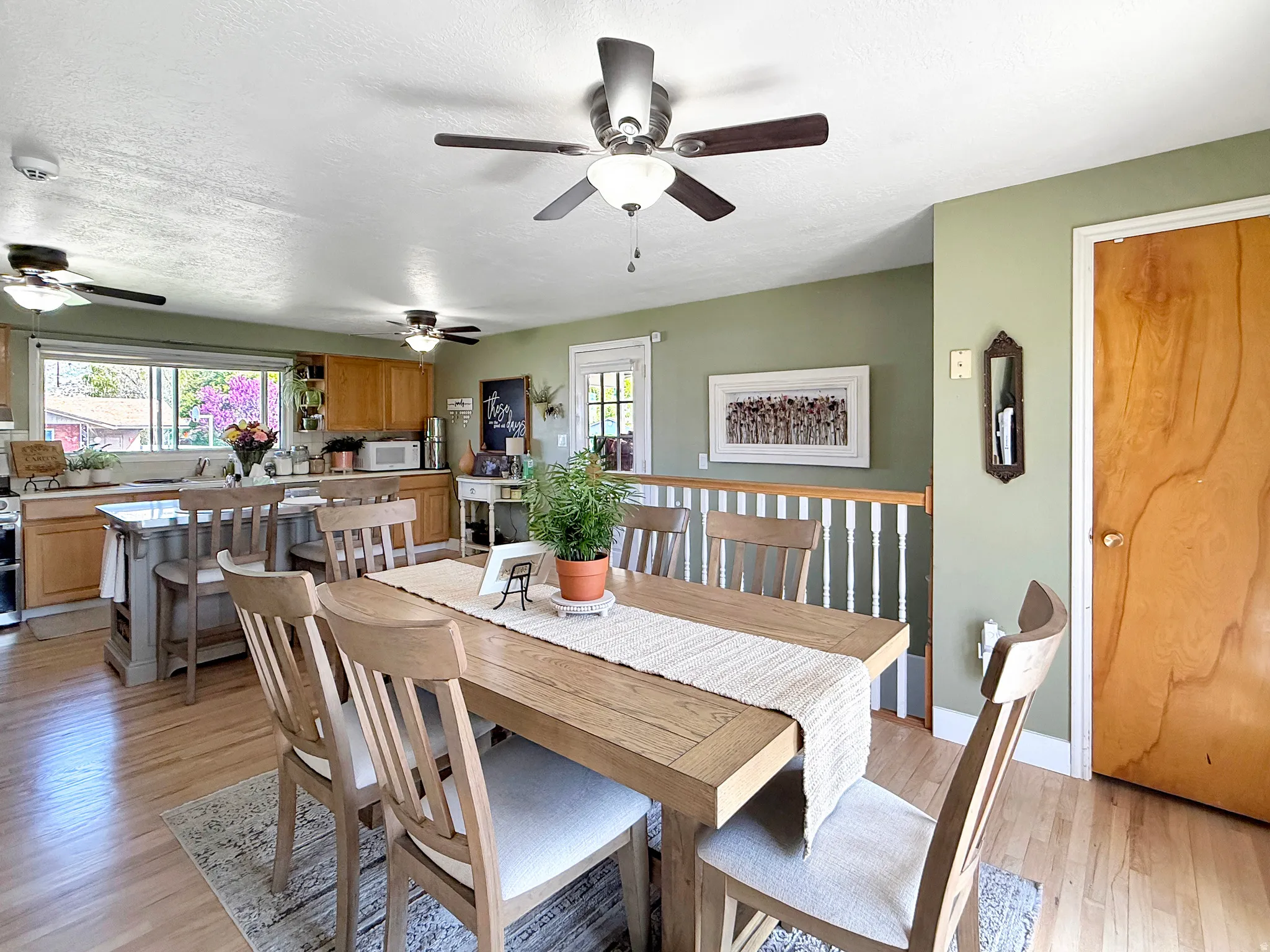 Dining area with light wood finished floors and a textured ceiling