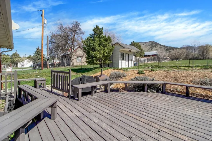 Wooden deck with an outbuilding and a mountain view