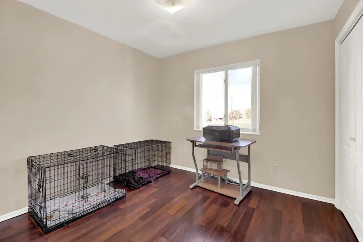 Home office with baseboards and dark wood finished floors