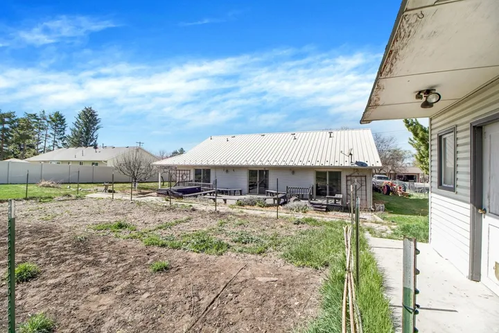 Back of property featuring a metal roof and a patio