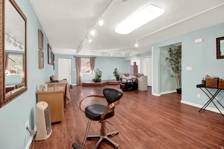 Office area featuring wood finished floors, rail lighting, and a textured ceiling