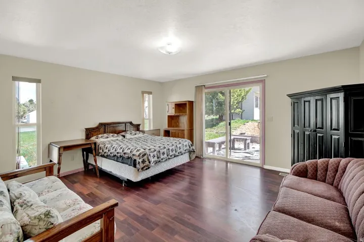 Bedroom with dark wood-type flooring and access to exterior