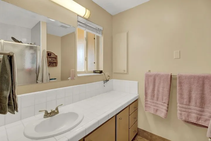 Bathroom with vanity and an enclosed shower