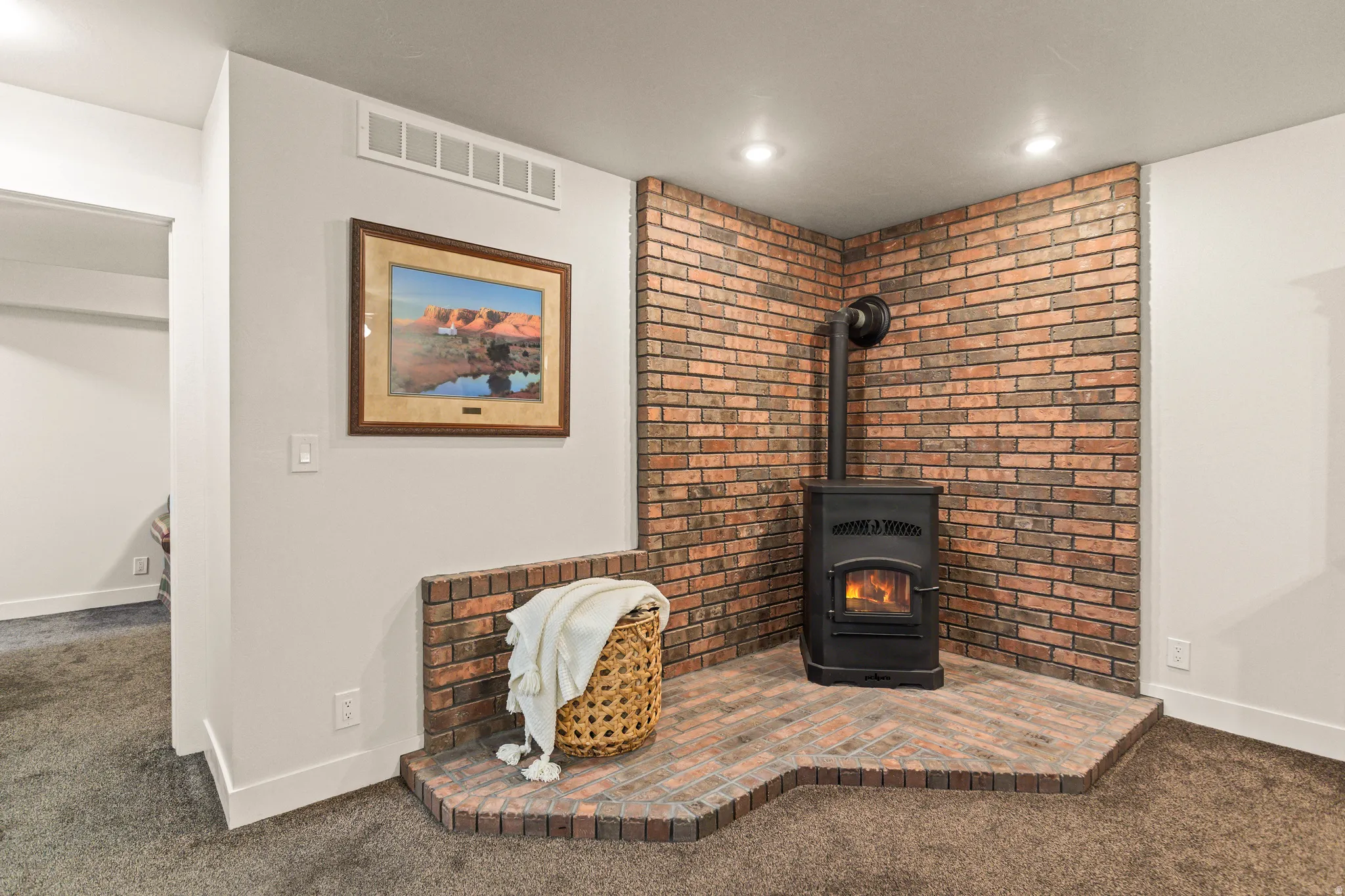 Detailed view of carpet floors and a wood stove