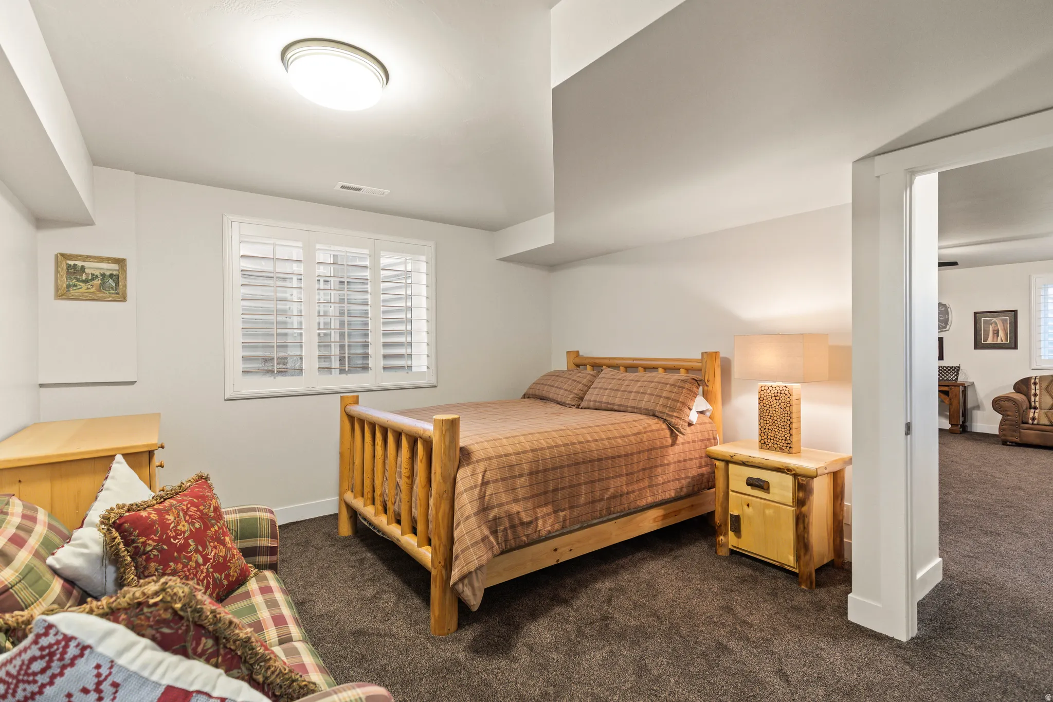 Bedroom featuring dark colored carpet and baseboards
