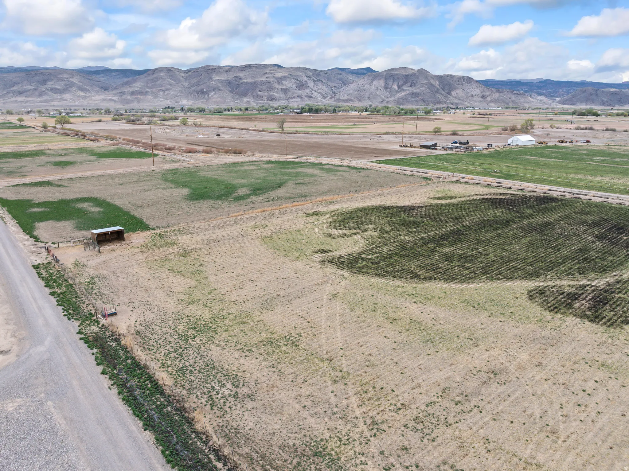 View of mountain backdrop with rural landscape and rows of crops