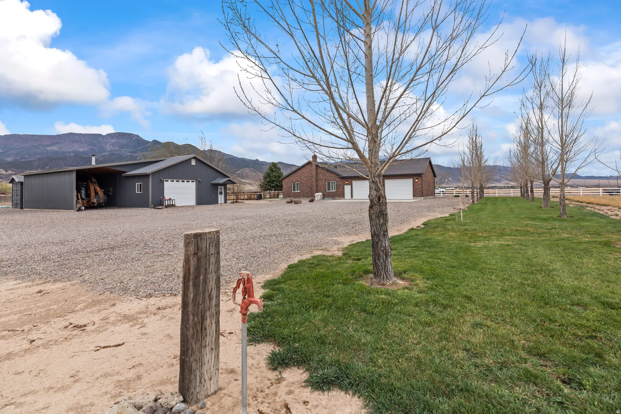 View of yard featuring a mountain view, a detached garage, and an outdoor structure