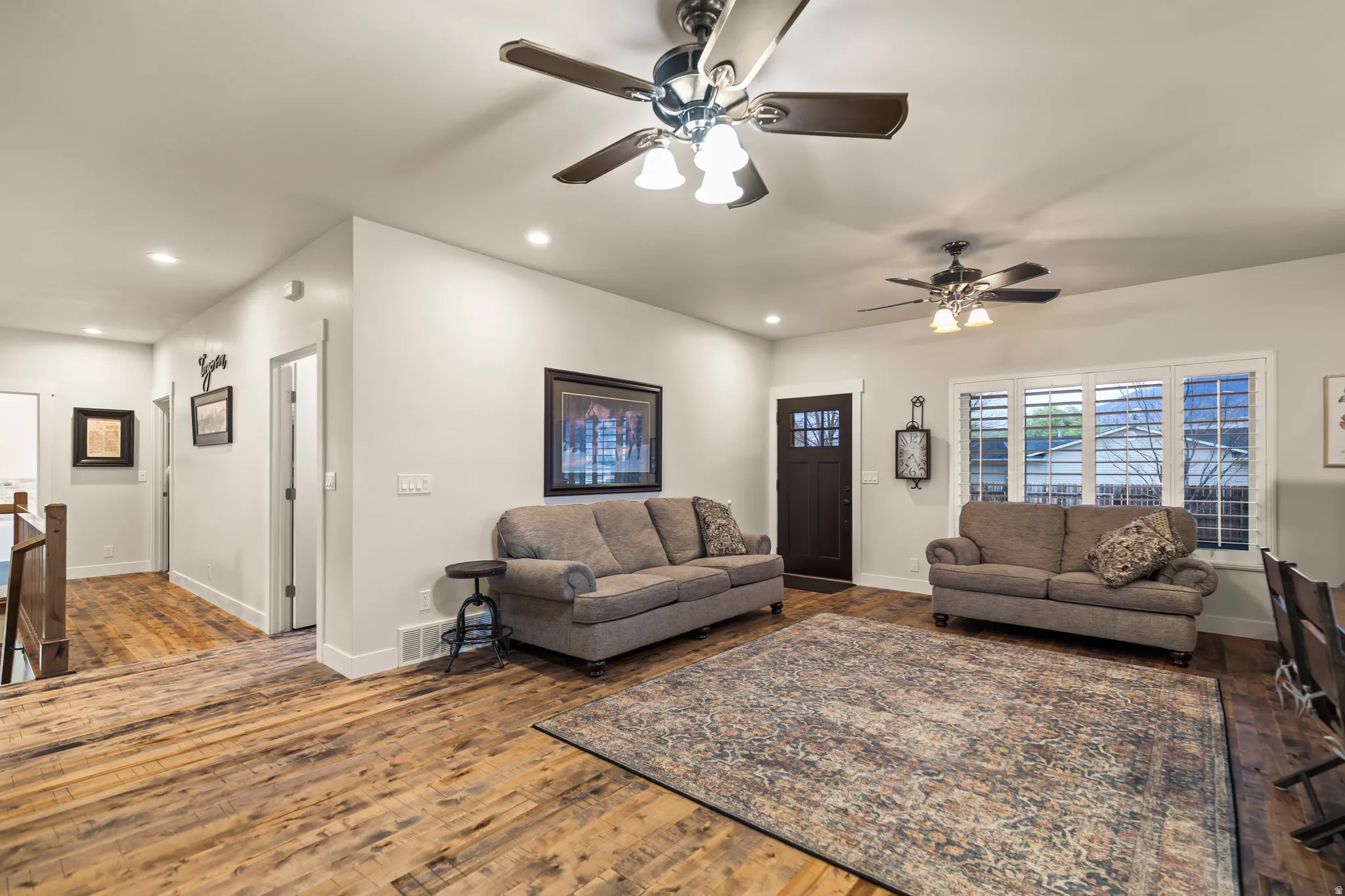 Living area featuring hardwood / wood-style floors, a ceiling fan, and recessed lighting