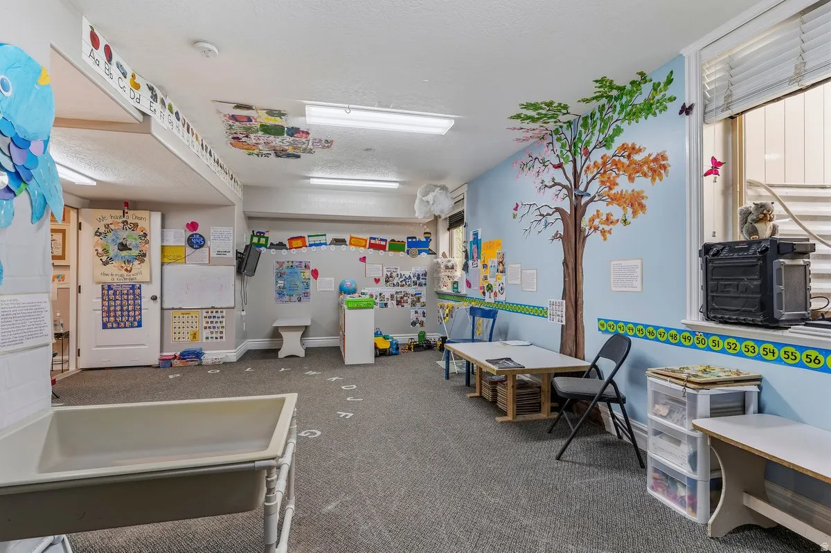 Playroom with dark carpet and baseboards