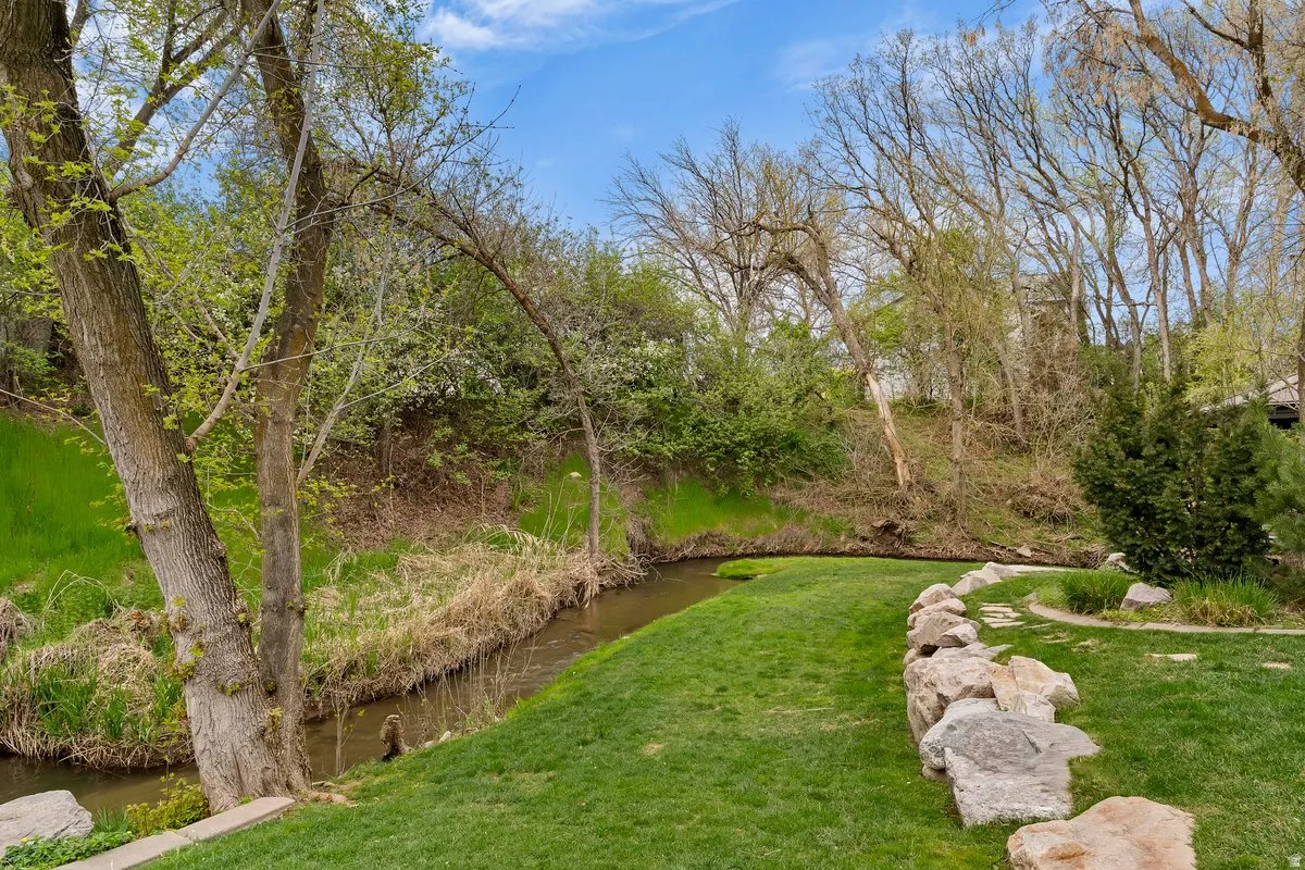 View of green lawn featuring a water view
