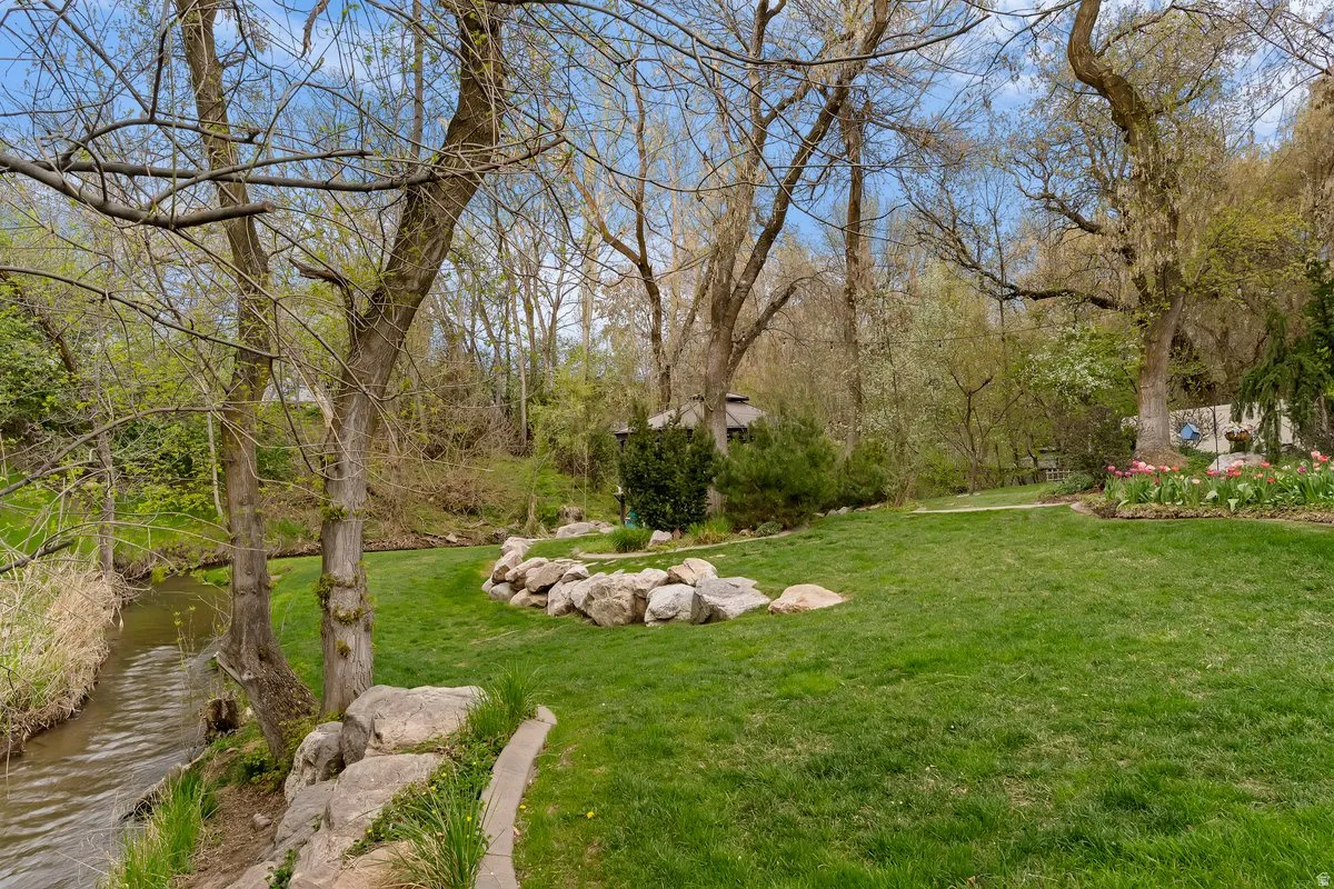 View of green lawn featuring a water view