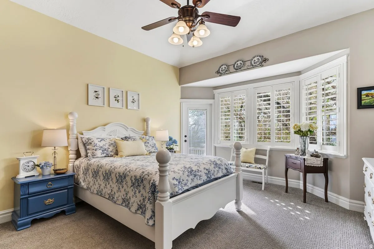 Bedroom with carpet flooring, a ceiling fan, and access to outside