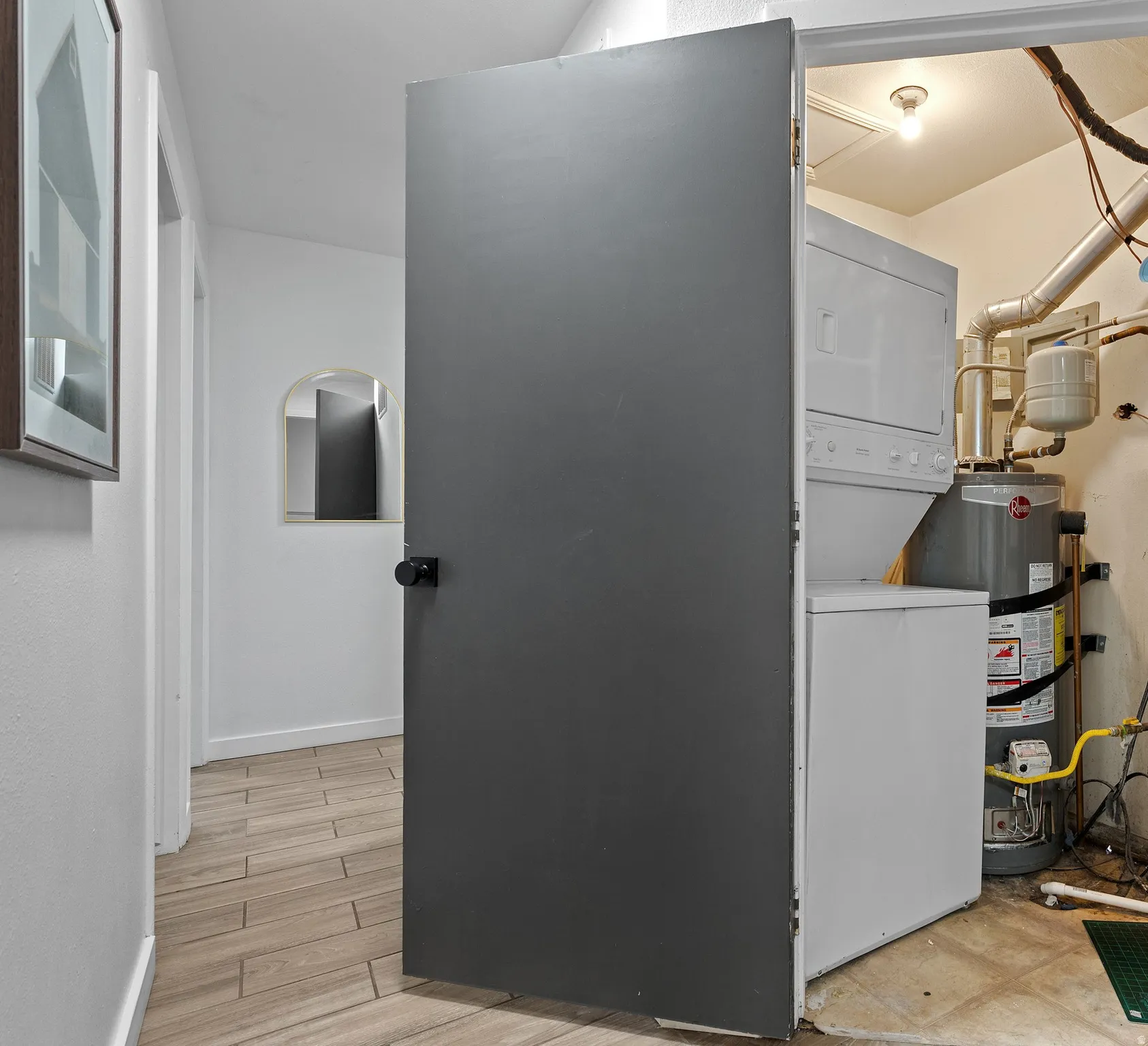 Utility room featuring stacked washer / dryer