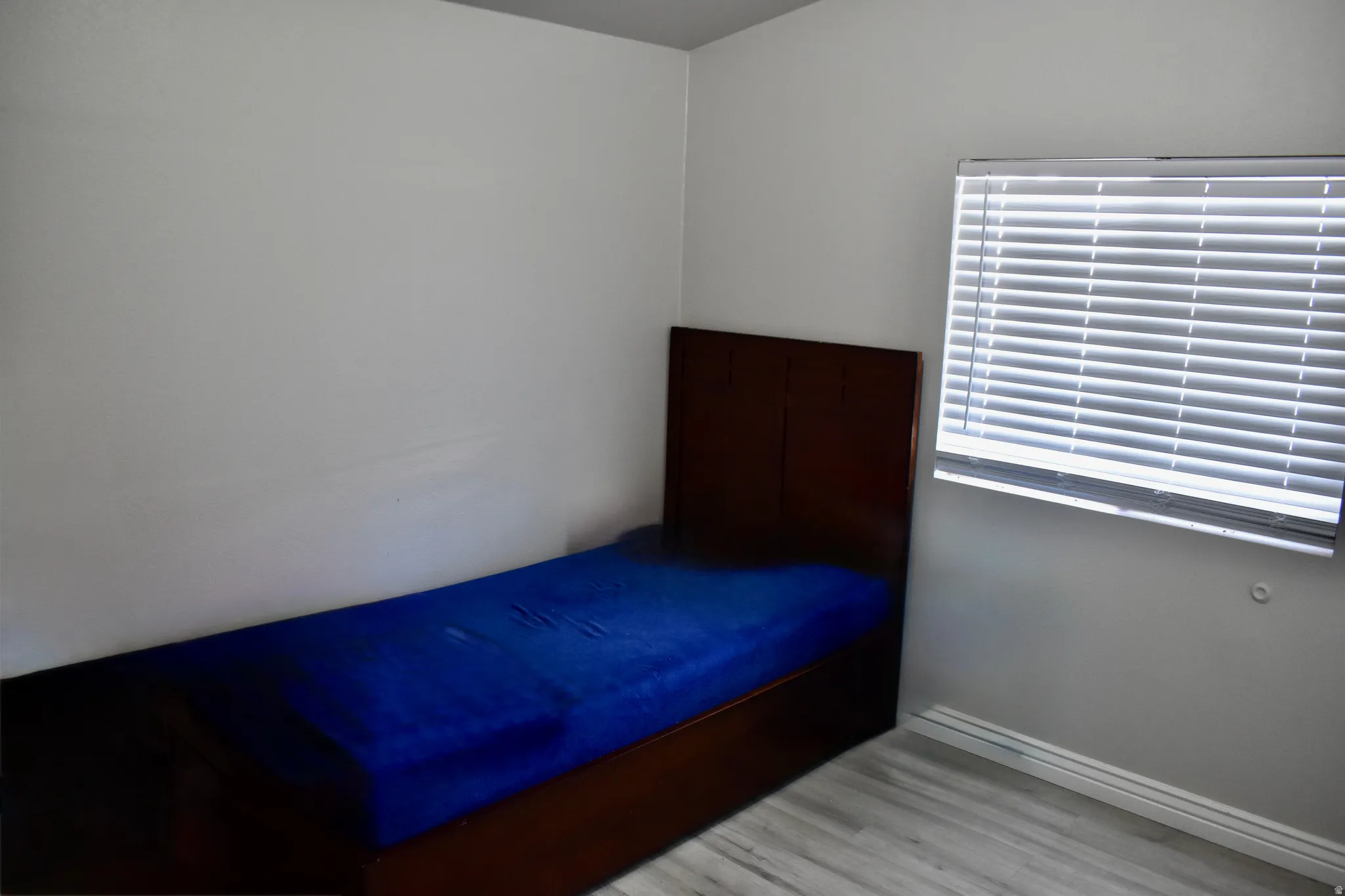 Unfurnished bedroom with light wood-style flooring and baseboards