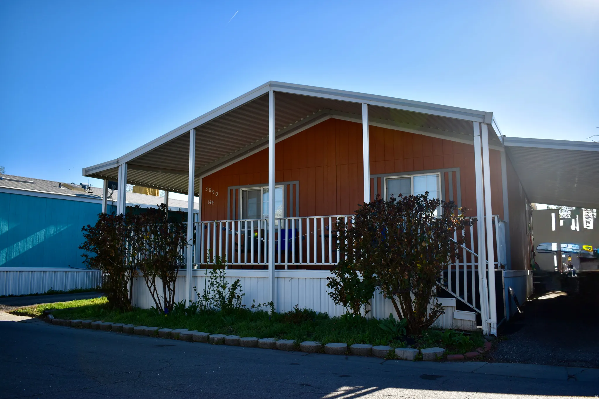 View of front of home with an attached carport and a porch