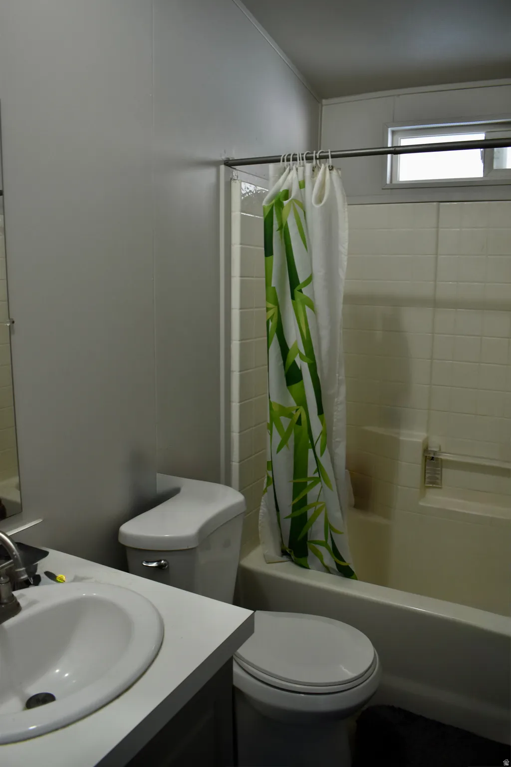 Full bath featuring vanity and shower / bathtub combination with curtain