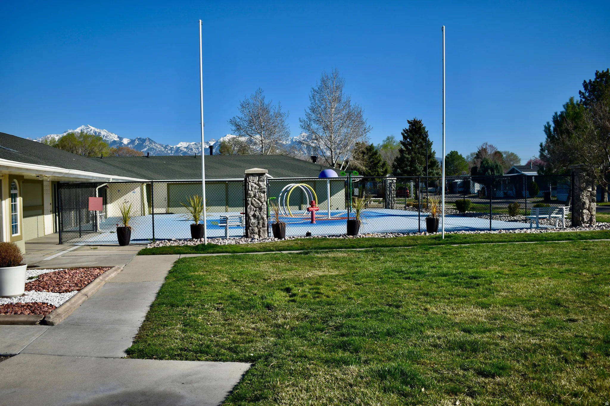 View of property's community with a splash pad and a mountain view