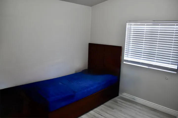 Unfurnished bedroom with light wood-style flooring and baseboards
