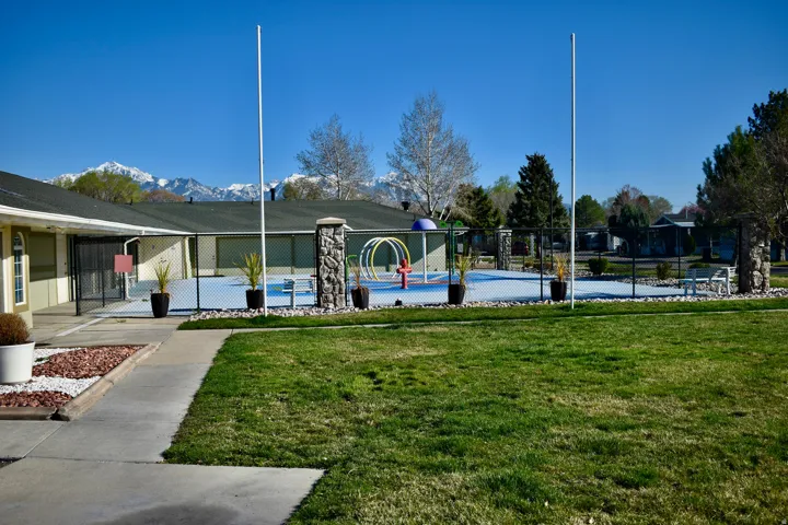 View of property's community with a splash pad and a mountain view