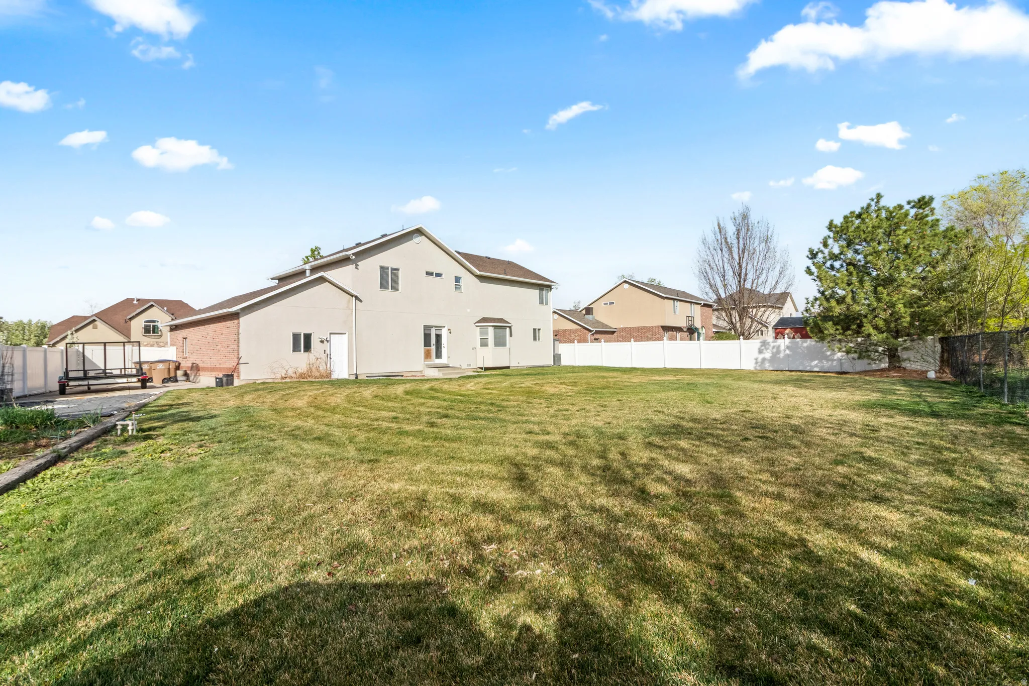 Back of house featuring a fenced backyard and a patio