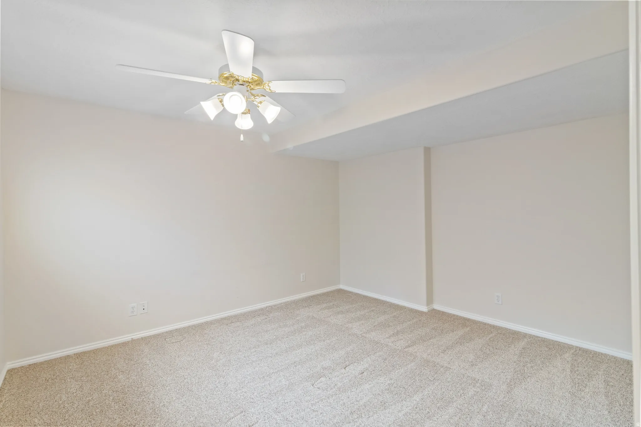 Spare room with light carpet and ceiling fan