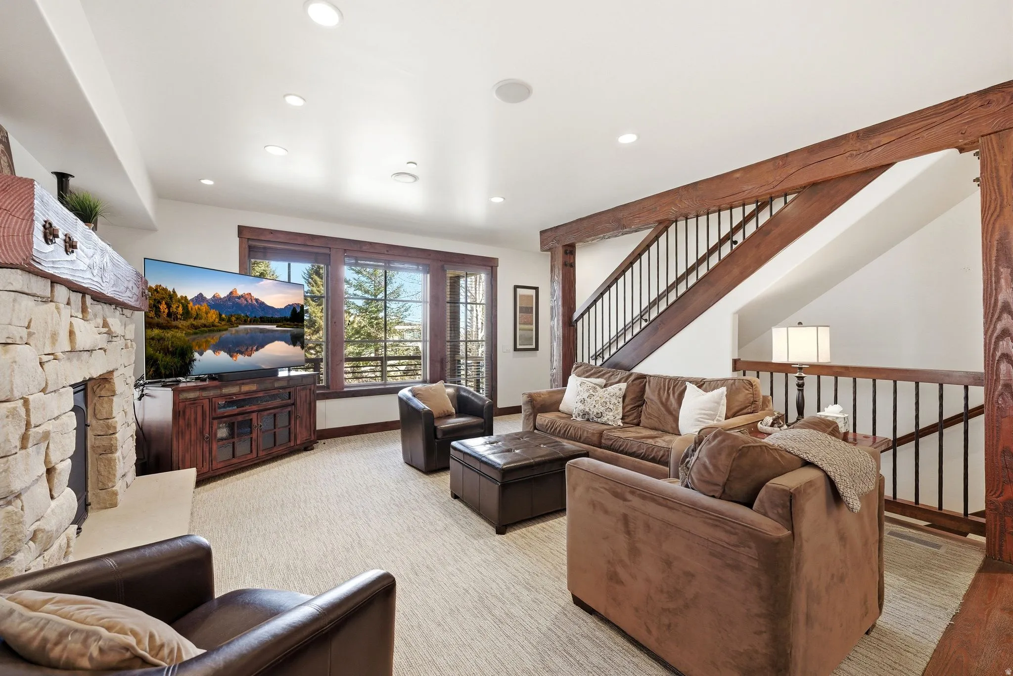 Living room featuring a fireplace, recessed lighting, and light colored carpet