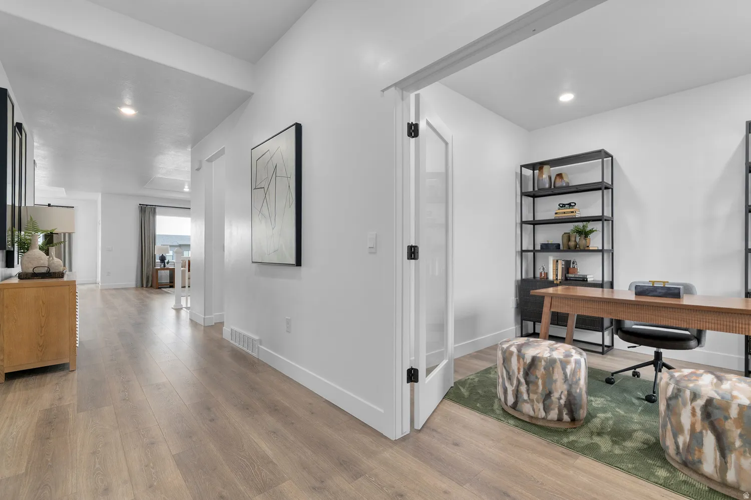 Office area with light wood-type flooring and recessed lighting