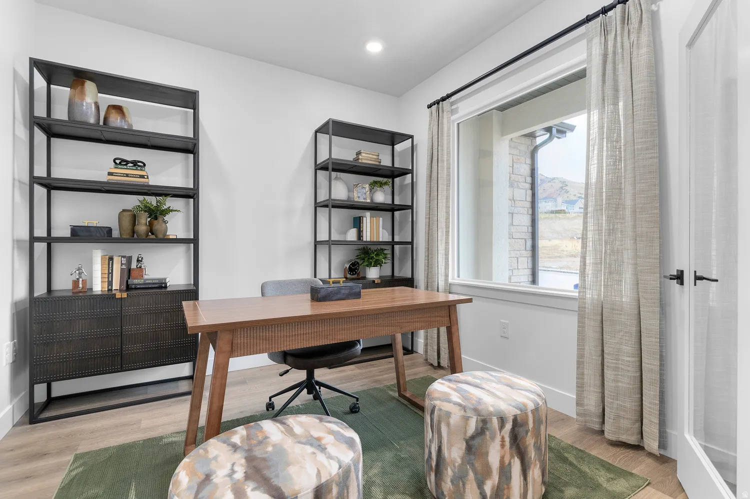 Home office with light wood-type flooring and recessed lighting