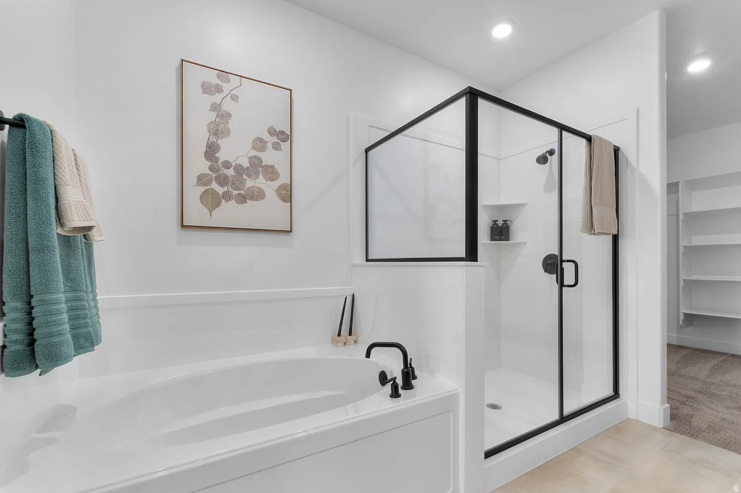 Full bath with a stall shower, a bath, a spacious closet, light carpet, and recessed lighting