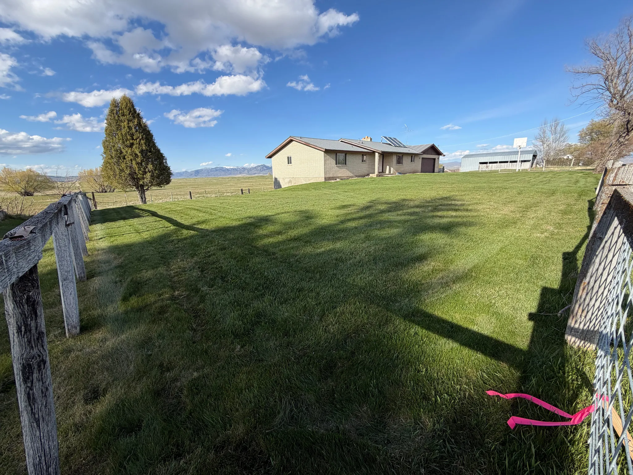 Fenced backyard featuring a rural view
