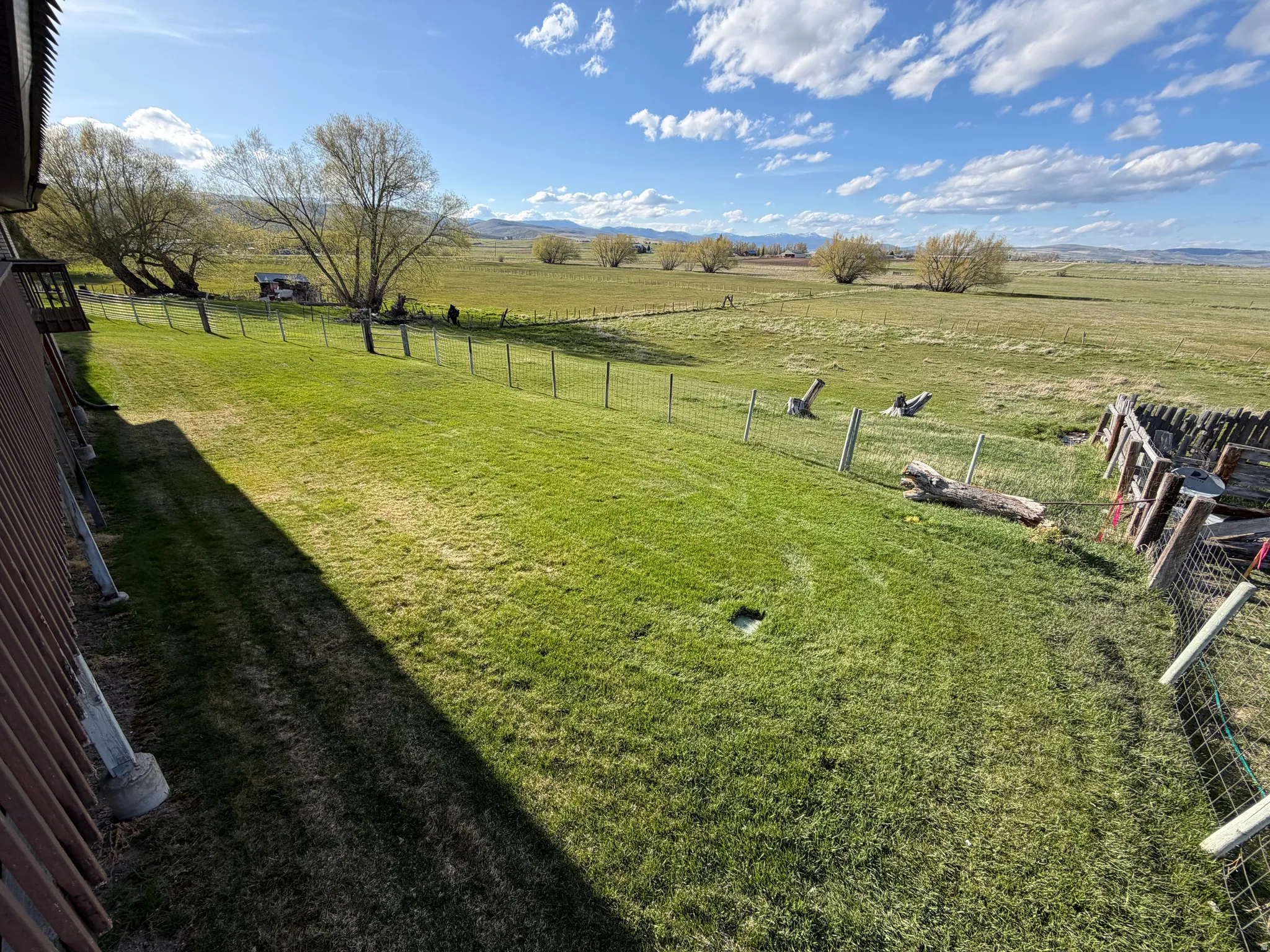 Fenced backyard featuring a view of countryside